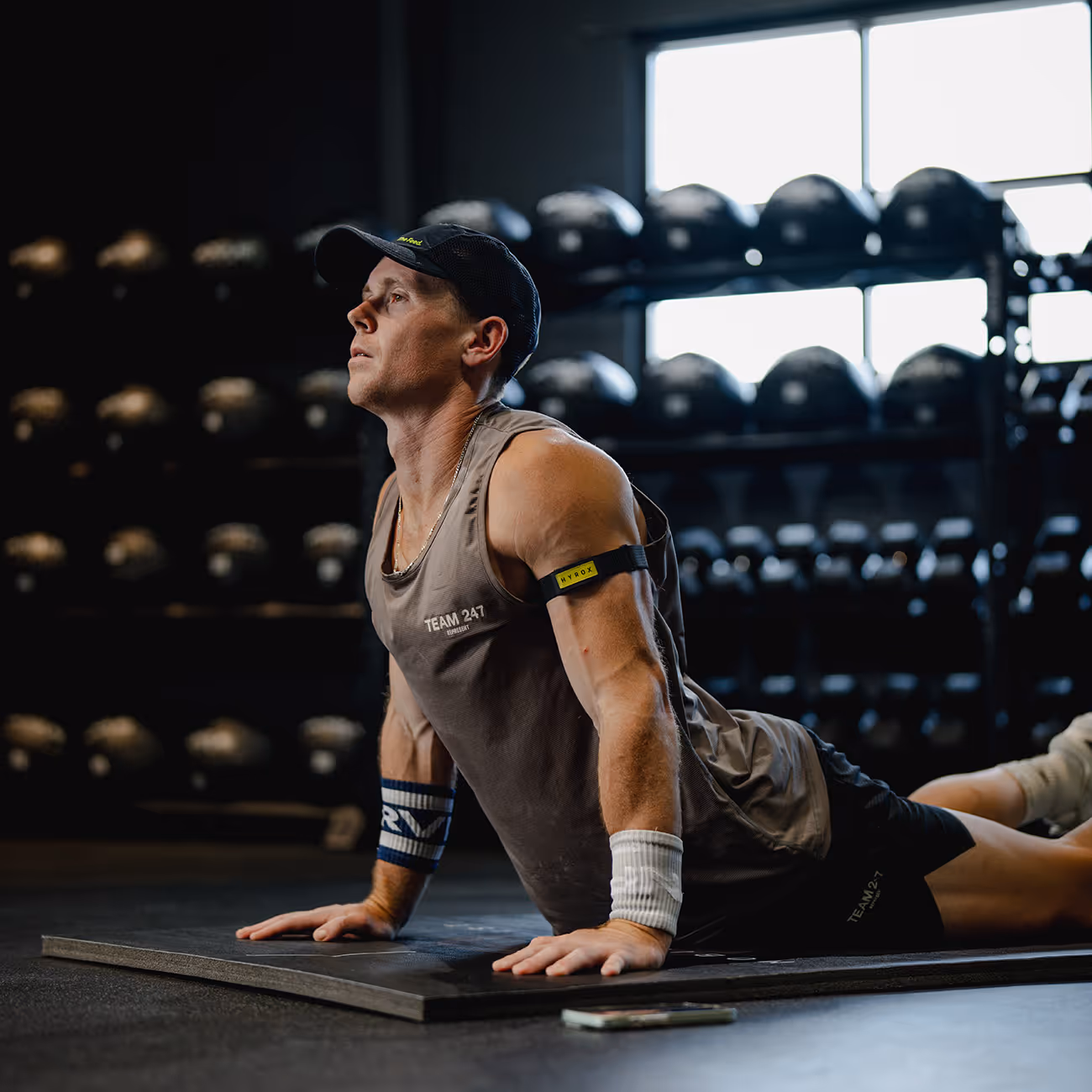Fit male stretching in a gym setting