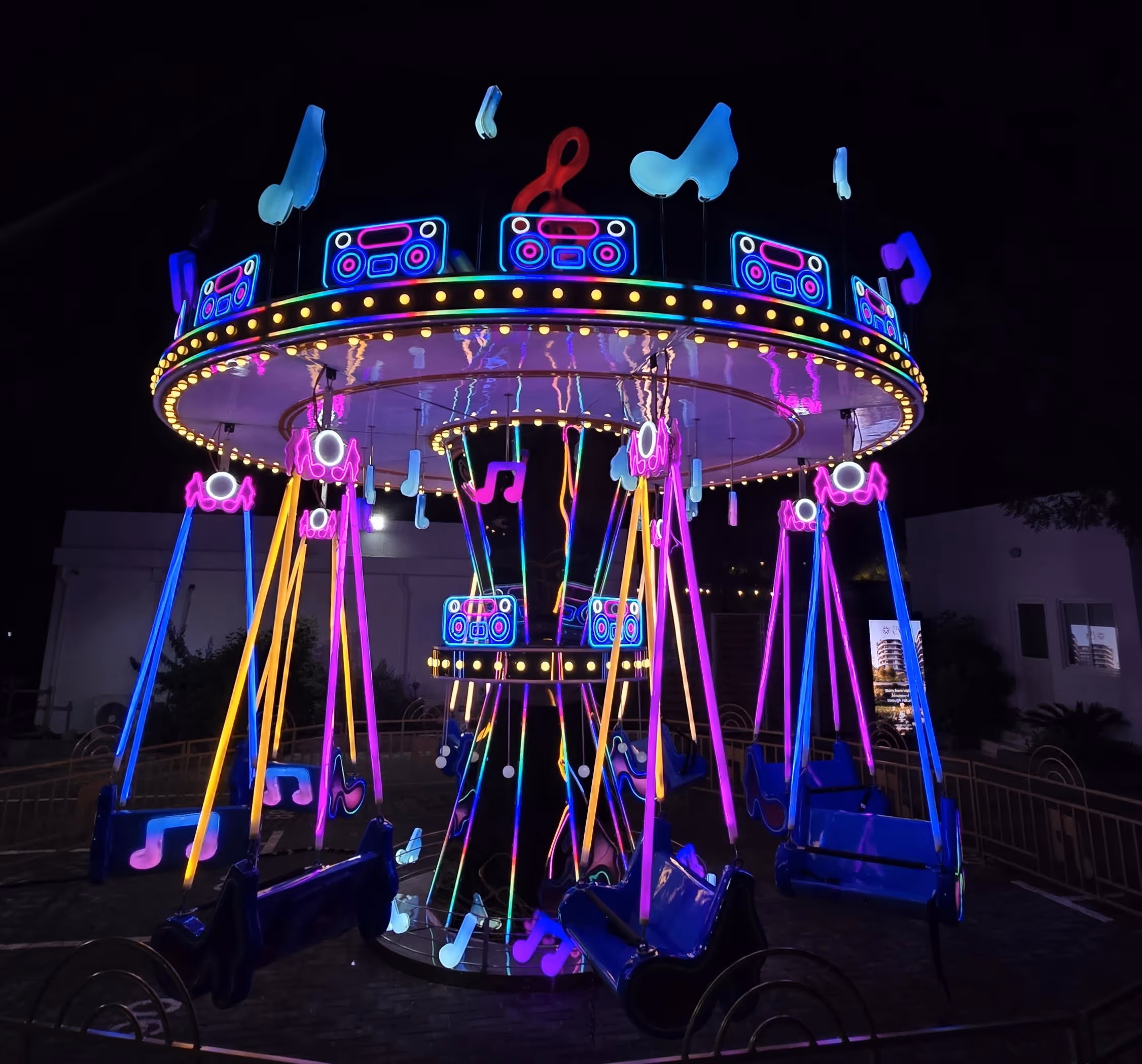 glowing carousel ride at night, in an event