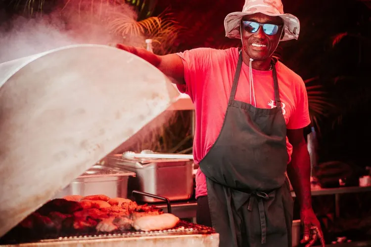 West Indian chef barbecuing under red lighting Bambouresort Martinique