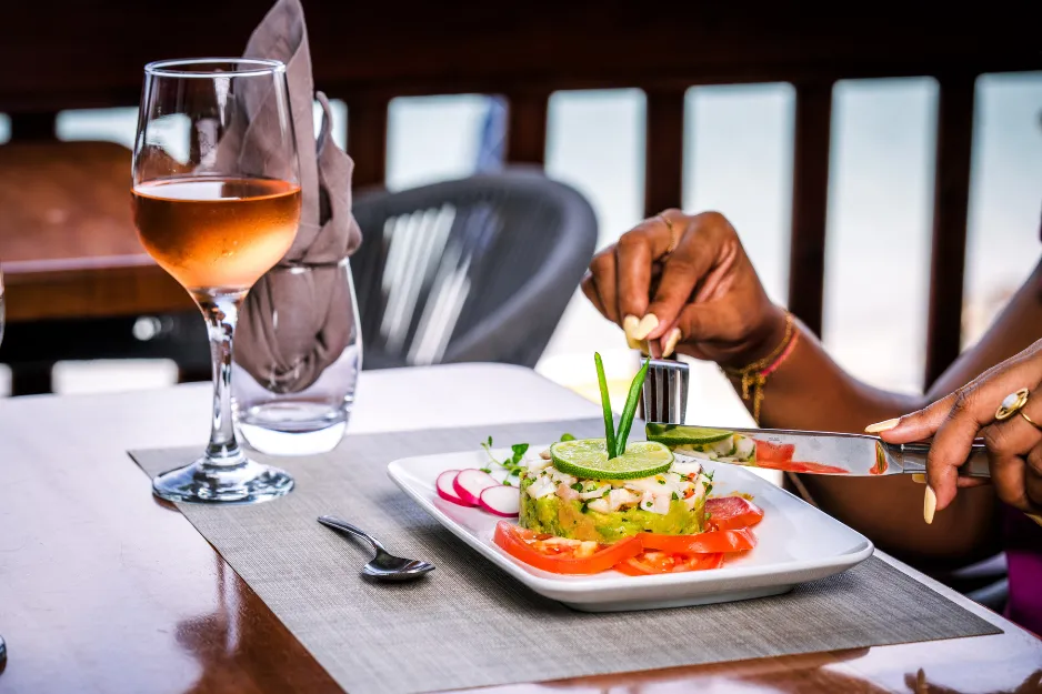 Gastronomic meal with a glass of rosé on the terrace of the Bambou Resort Martinique restaurant