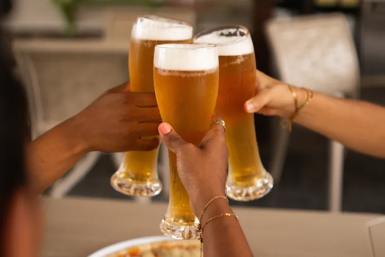 Glasses of cold beer toasting at the Bambou Resort Martinique bar