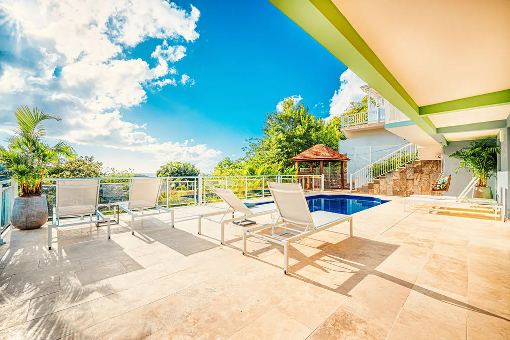 Terrace luxury villa with private pool and deckchairs sea view Martinique