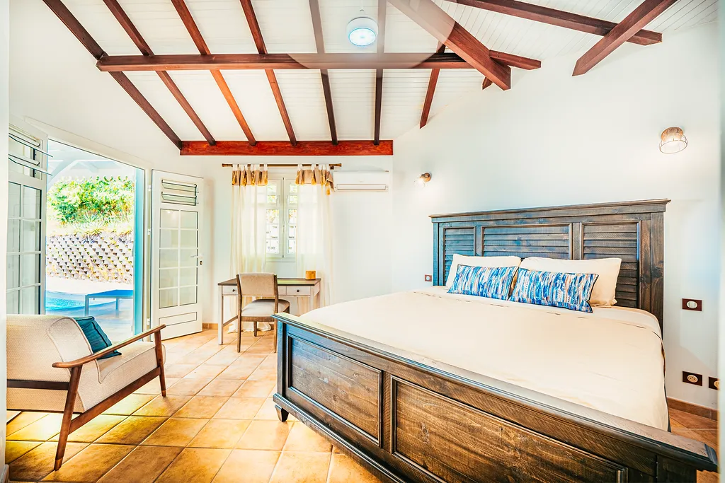 Luxury room villa Bambou Resort exposed beams terracotta floor tropical view Martinique