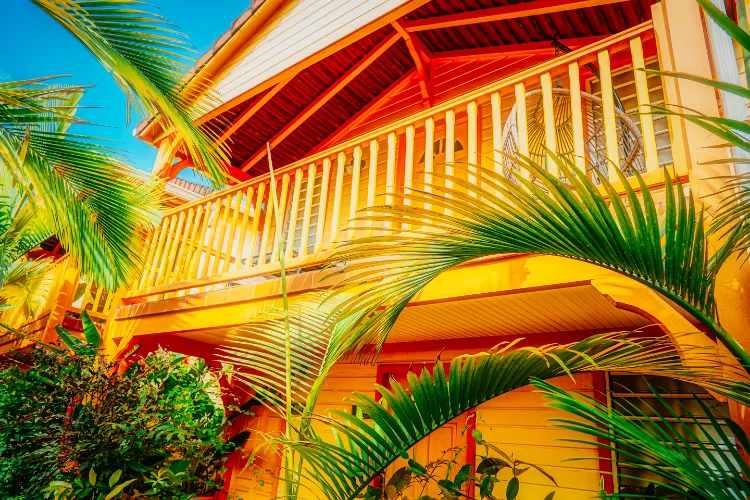 Bungalow Harmonie balcony exotic wood lush palm trees Bambou Resort Martinique