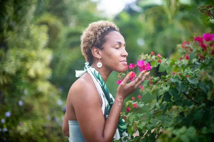 Holidaymaker admiring tropical flowers in lush garden Bambouresort Martinique