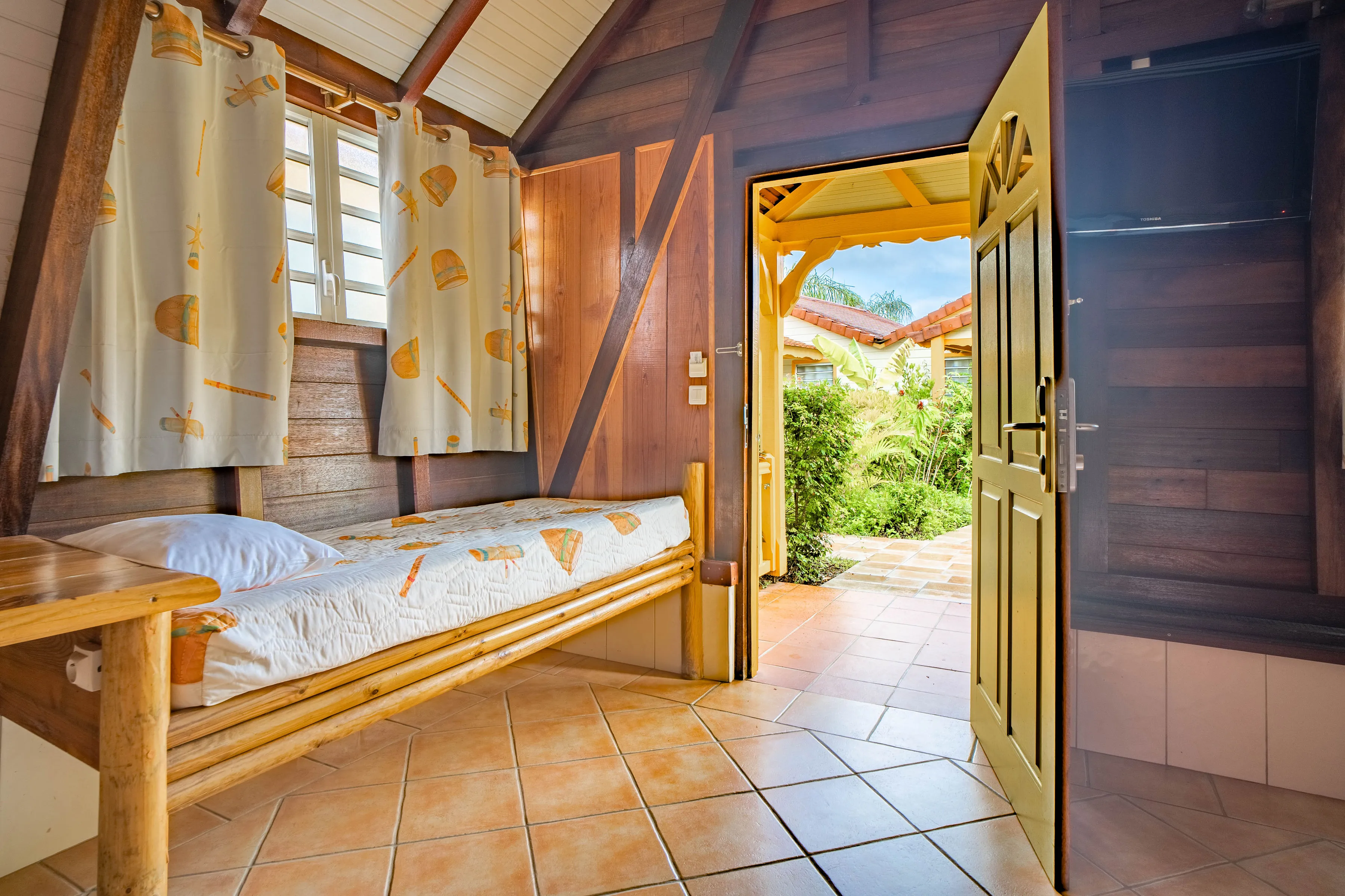 Luxury wooden bungalow Bambou Resort bamboo bed tiles tropical garden view Martinique