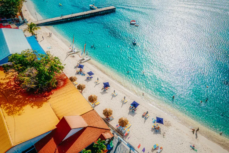 Private beach Bambou Resort Martinique blue deckchairs turquoise water pontoon boats