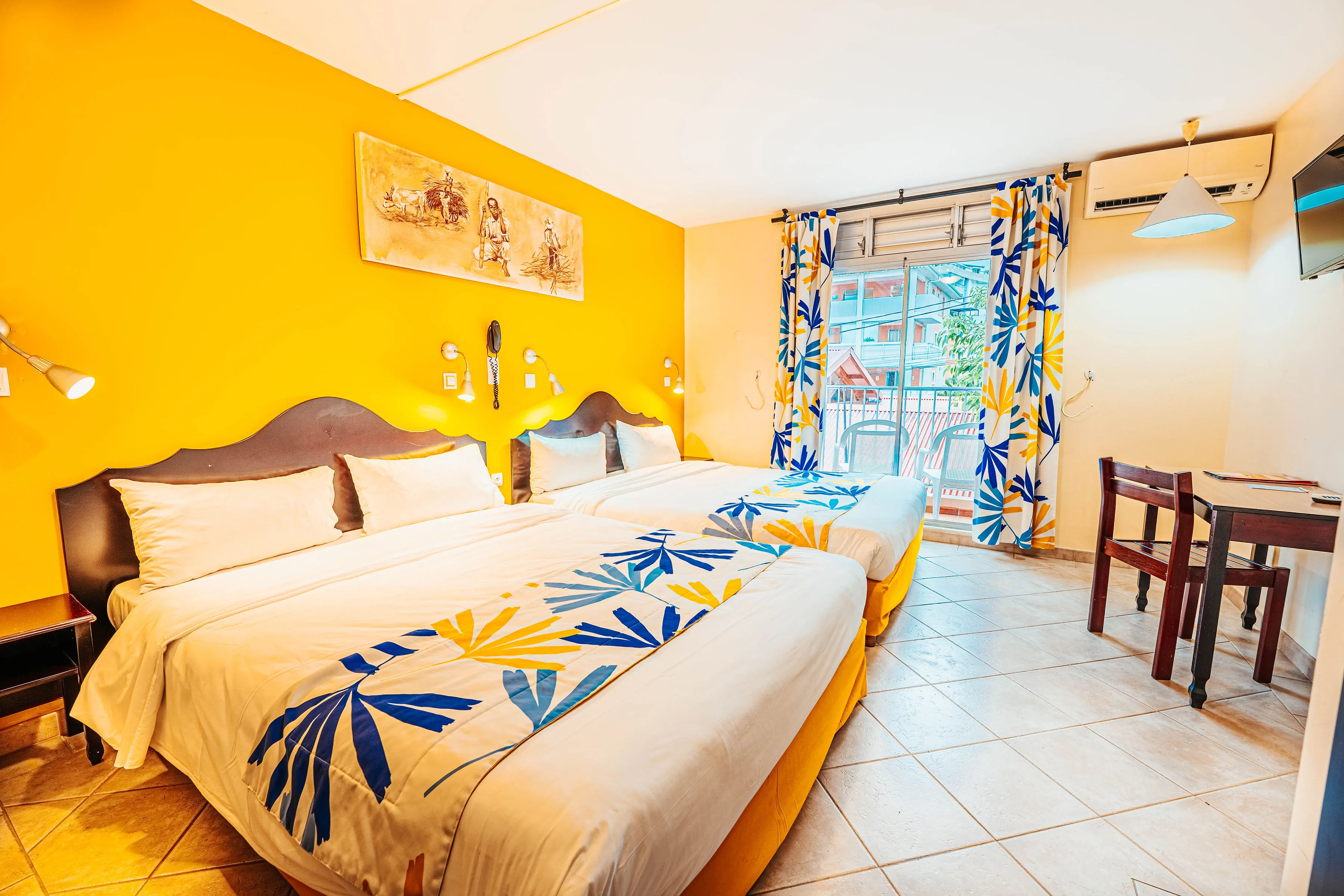 Family room Gran Kay king size bed tropical motifs yellow wall Bambouresort Martinique