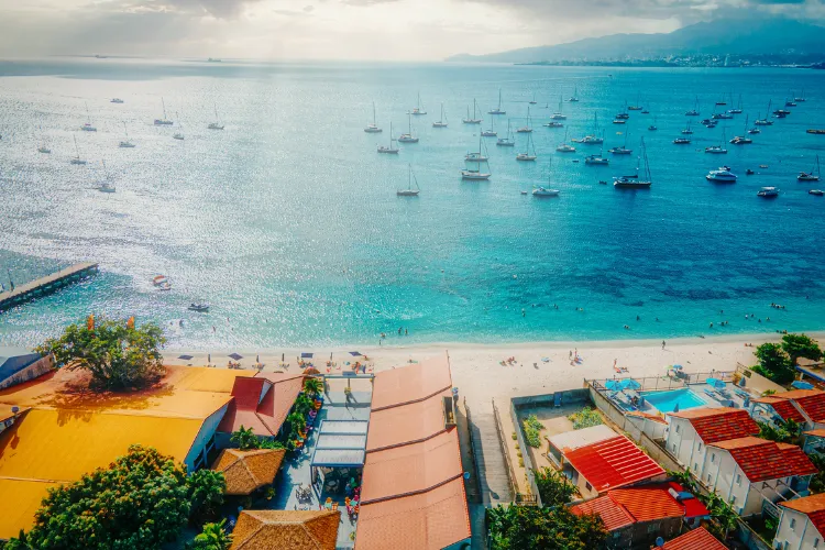 Tropical bay aerial view with anchored sailboats turquoise waters beach Martinique