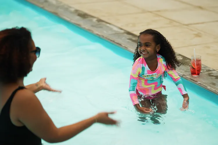 Young holidaymaker having fun in the turquoise pool at the Bambou Resort Martinique