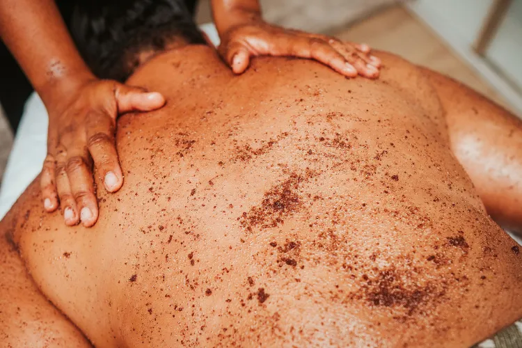 Coffee body scrub applied during a Martinique luxury spa massage