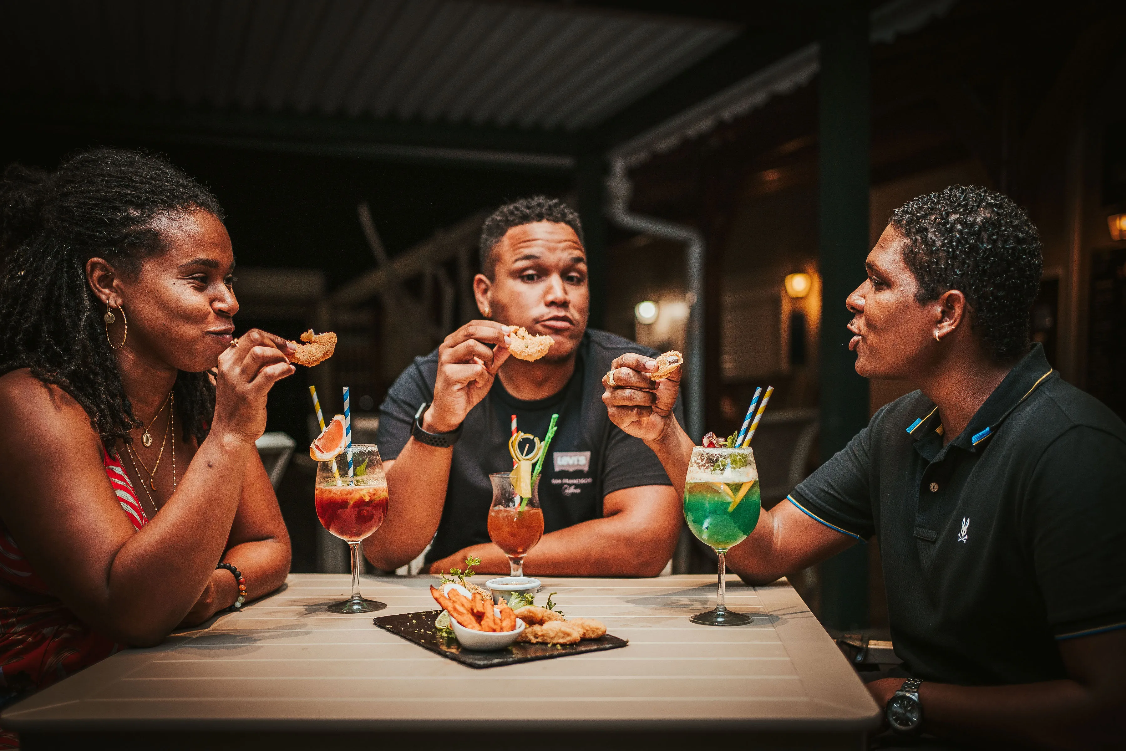 Friends enjoying tropical cocktails and tapas at the Bambou Resort Martinique restaurant
