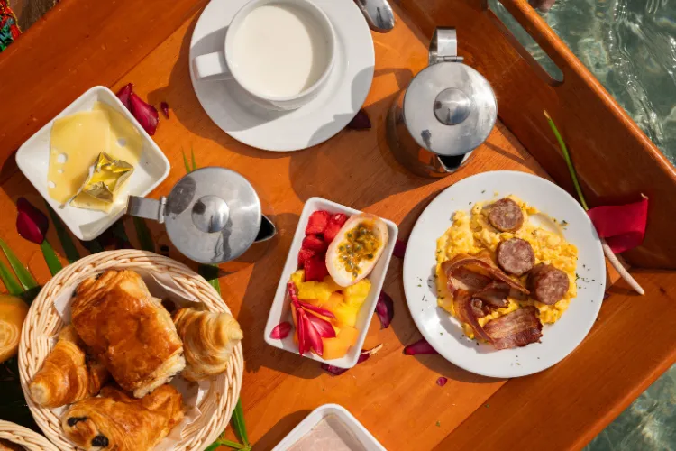 Gourmet breakfast served on a wooden tray with pastries, coffee and fruit BambouResort Martinique