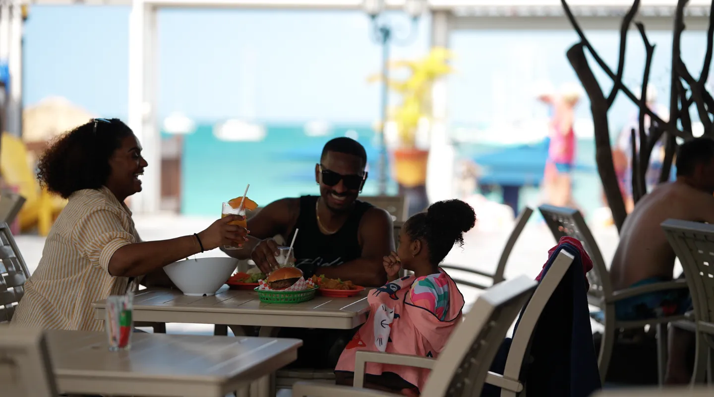 Guests enjoying cocktails and Creole specialties at the Karayib Bambou Resort Martinique restaurant