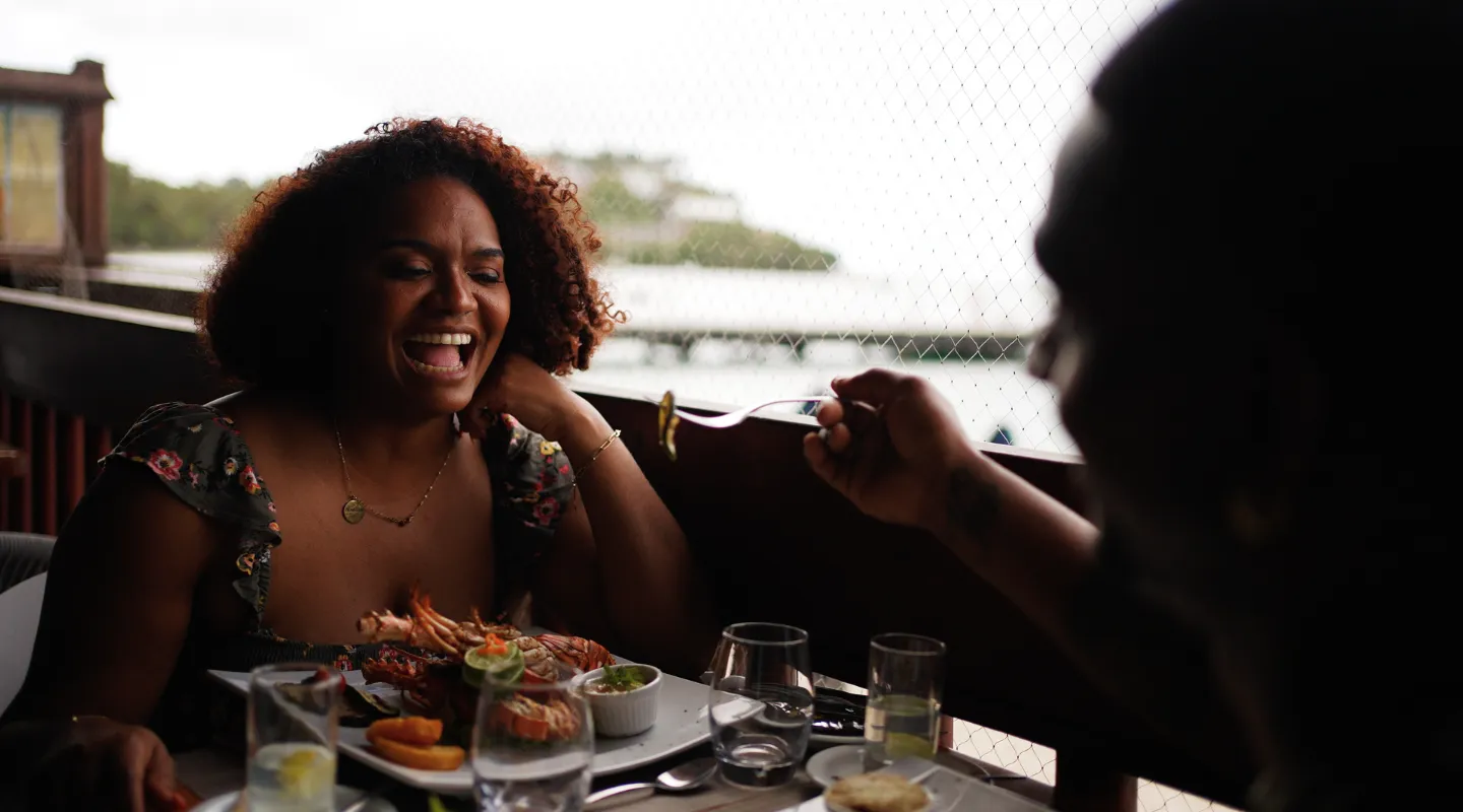 Guests enjoying a gourmet meal on the terrace of the Bòdlanmè restaurant with sea view of Martinique