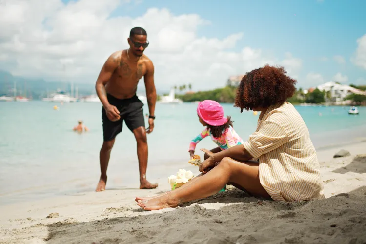 Family enjoying beach activities at Bambou Resort Martinique turquoise sea