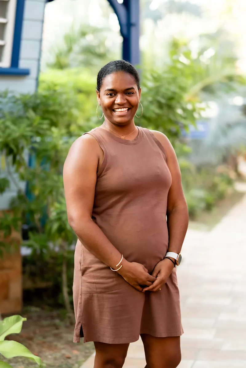 Friendly staff in brown suits posing in a tropical garden Bambouresort Martinique