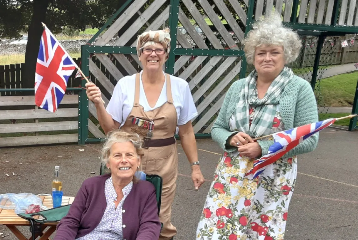village fate with ladies waving flags