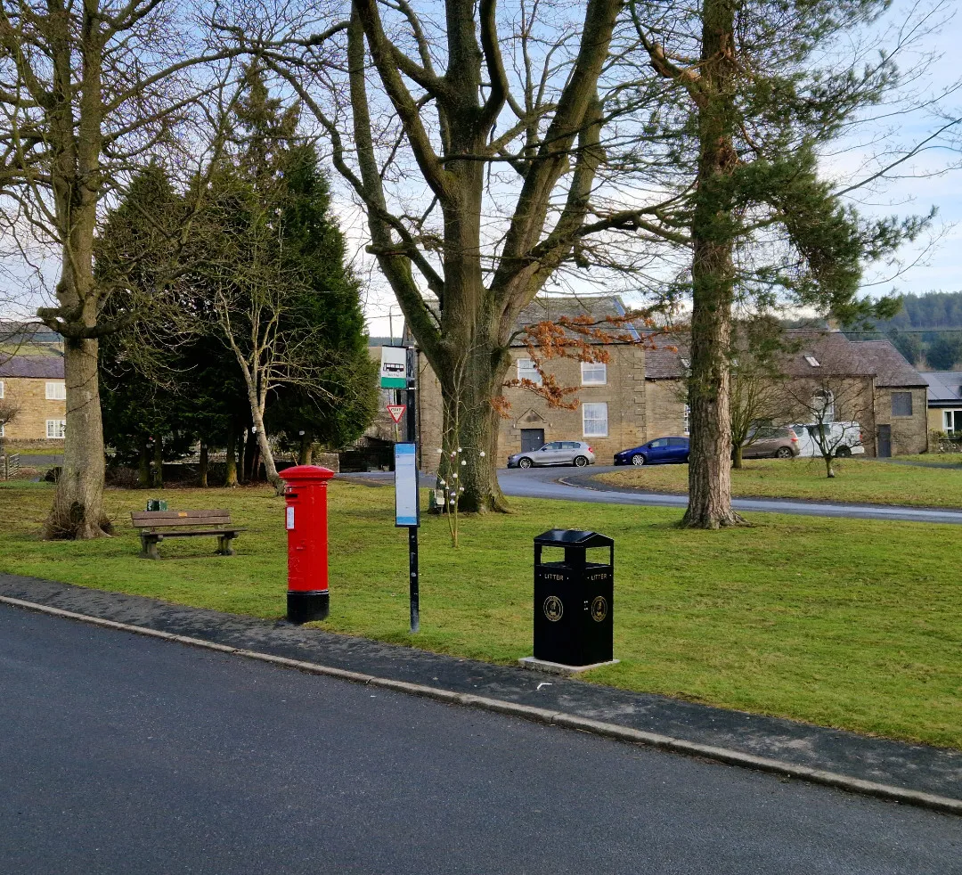 road through village with letter box