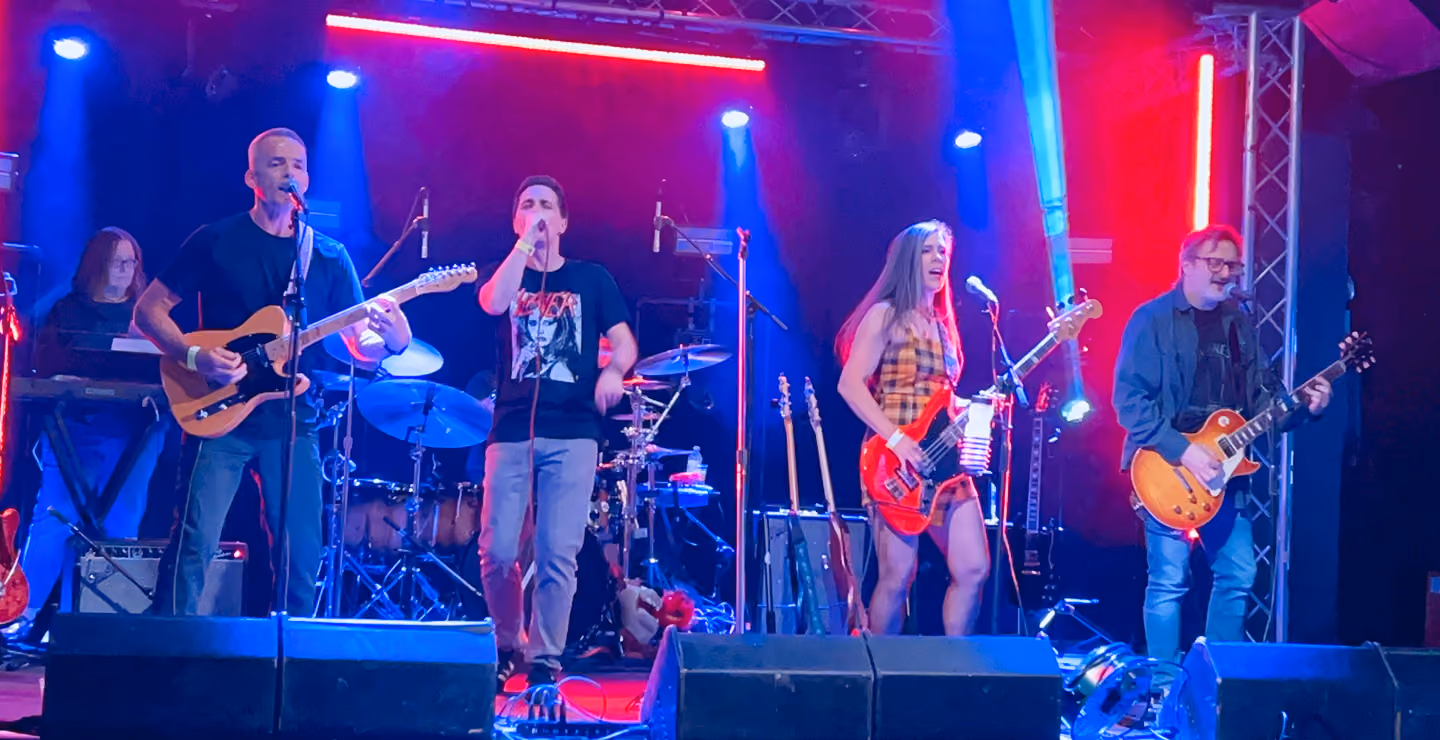 Like a Stone band members performing on stage