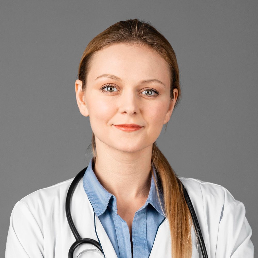 Portrait of a smiling female doctor wearing a white coat and stethoscope.