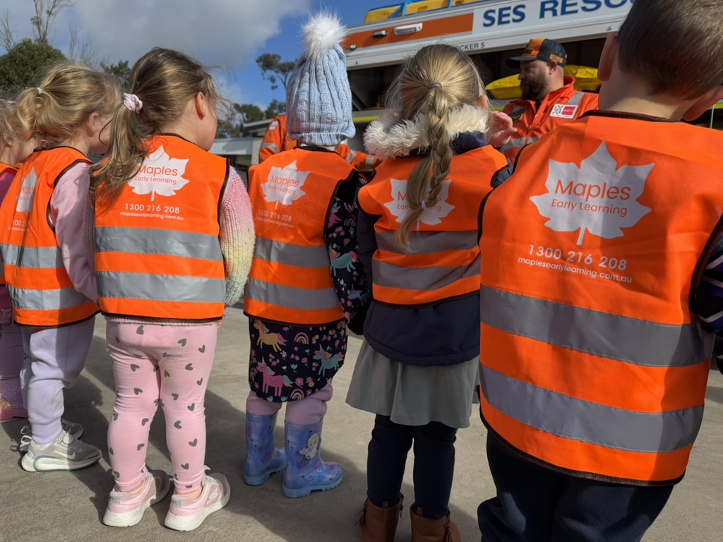 Maples children on an excursion wearing orange safety vests