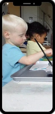 The Maples app on a phone showing children painting