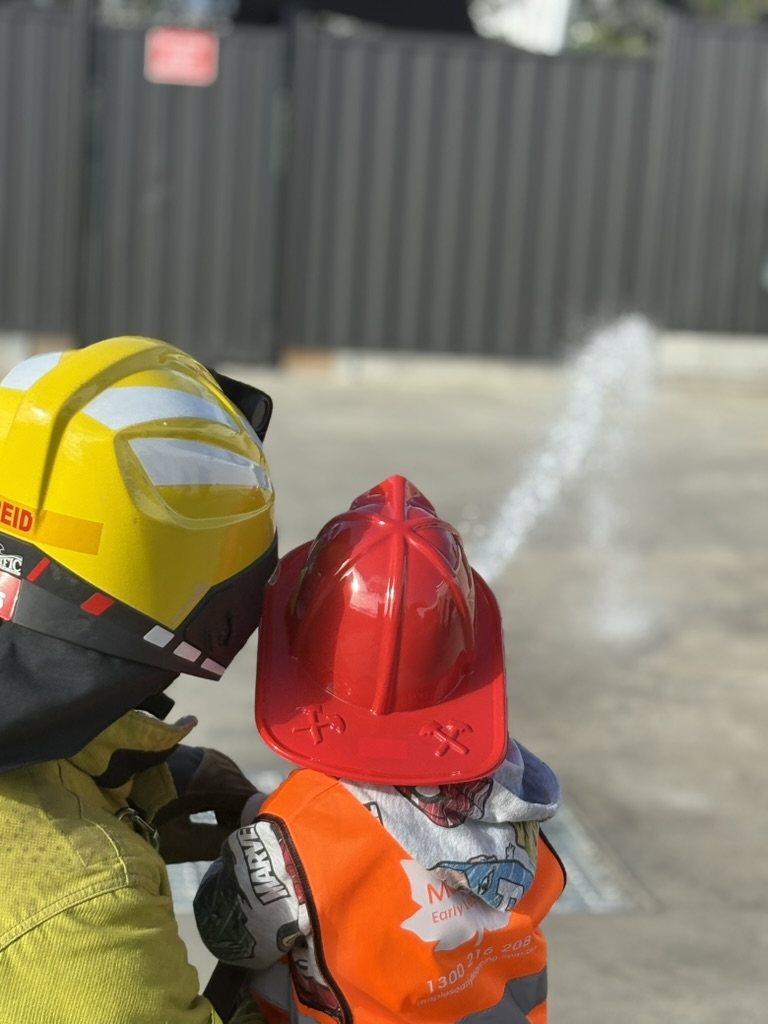 A child with a firefighter during an incursion