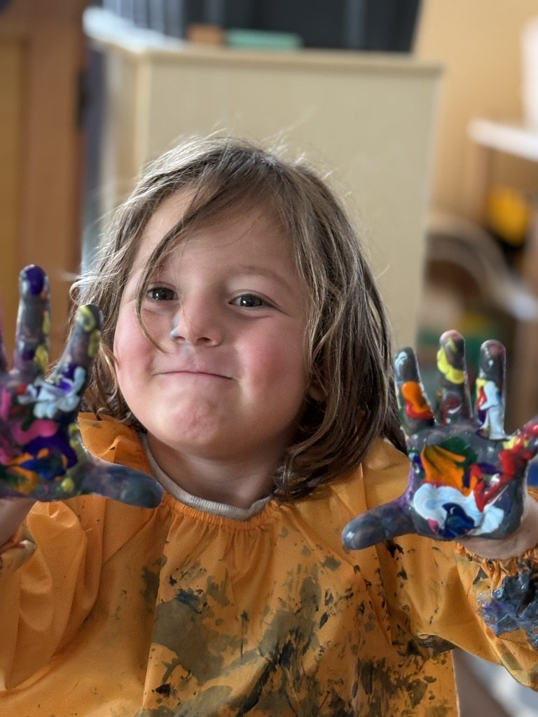 A child showing painted hands