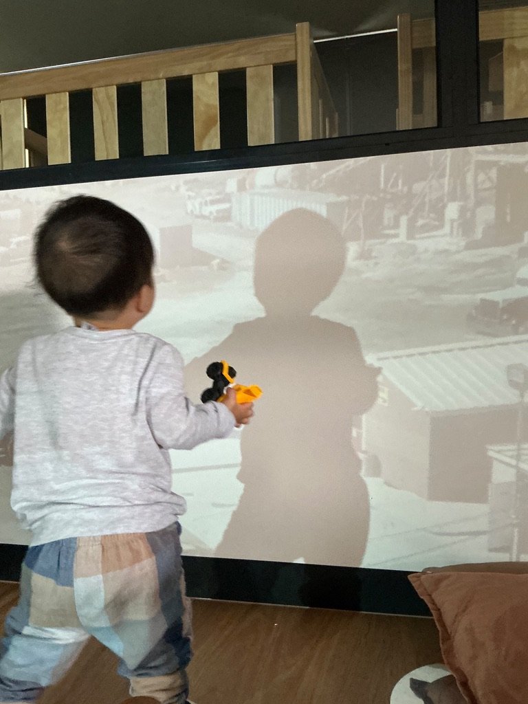 A toddler playing with shadows
