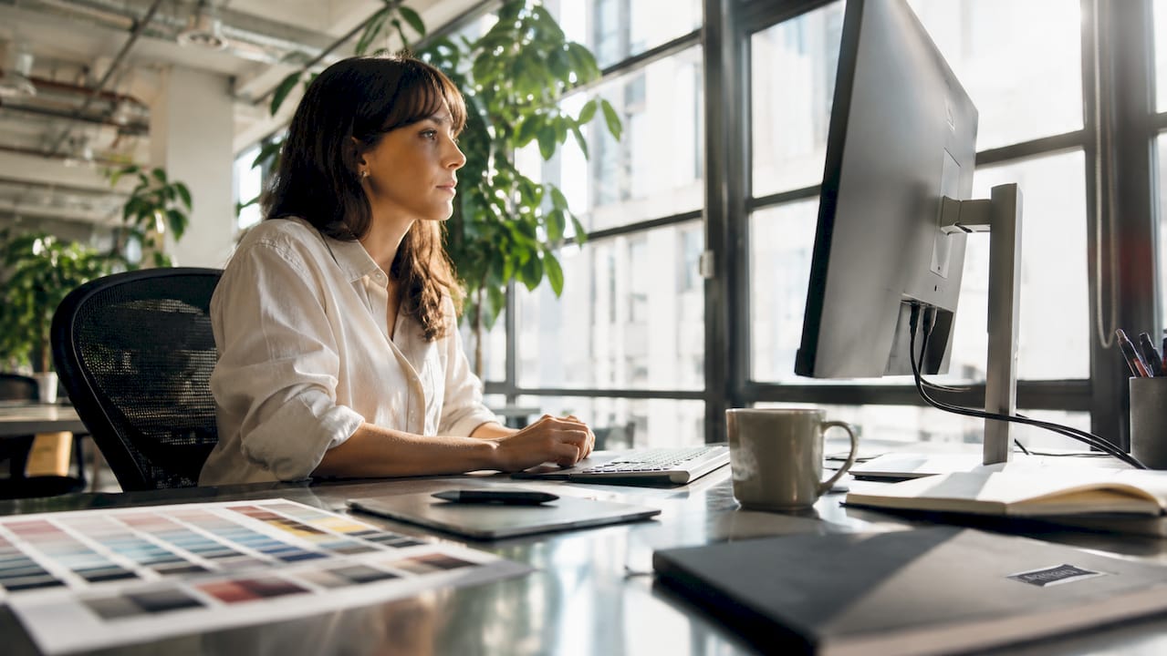 UI designer working at computer in home office