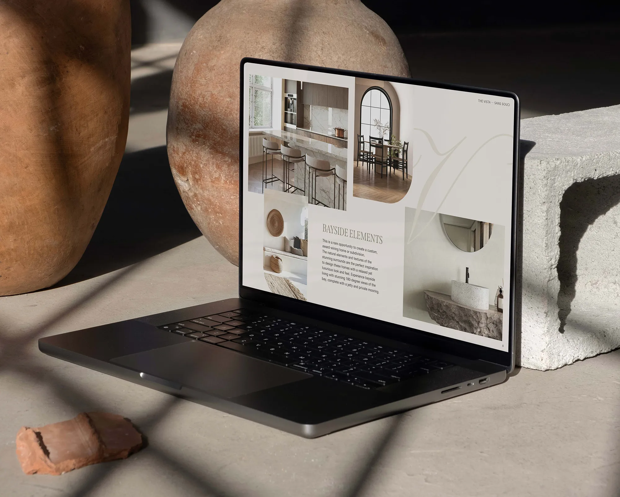 The Vista Sans Souci marketing presentation on laptop highlighting bayside design elements, premium finishes, and luxury lifestyle.
