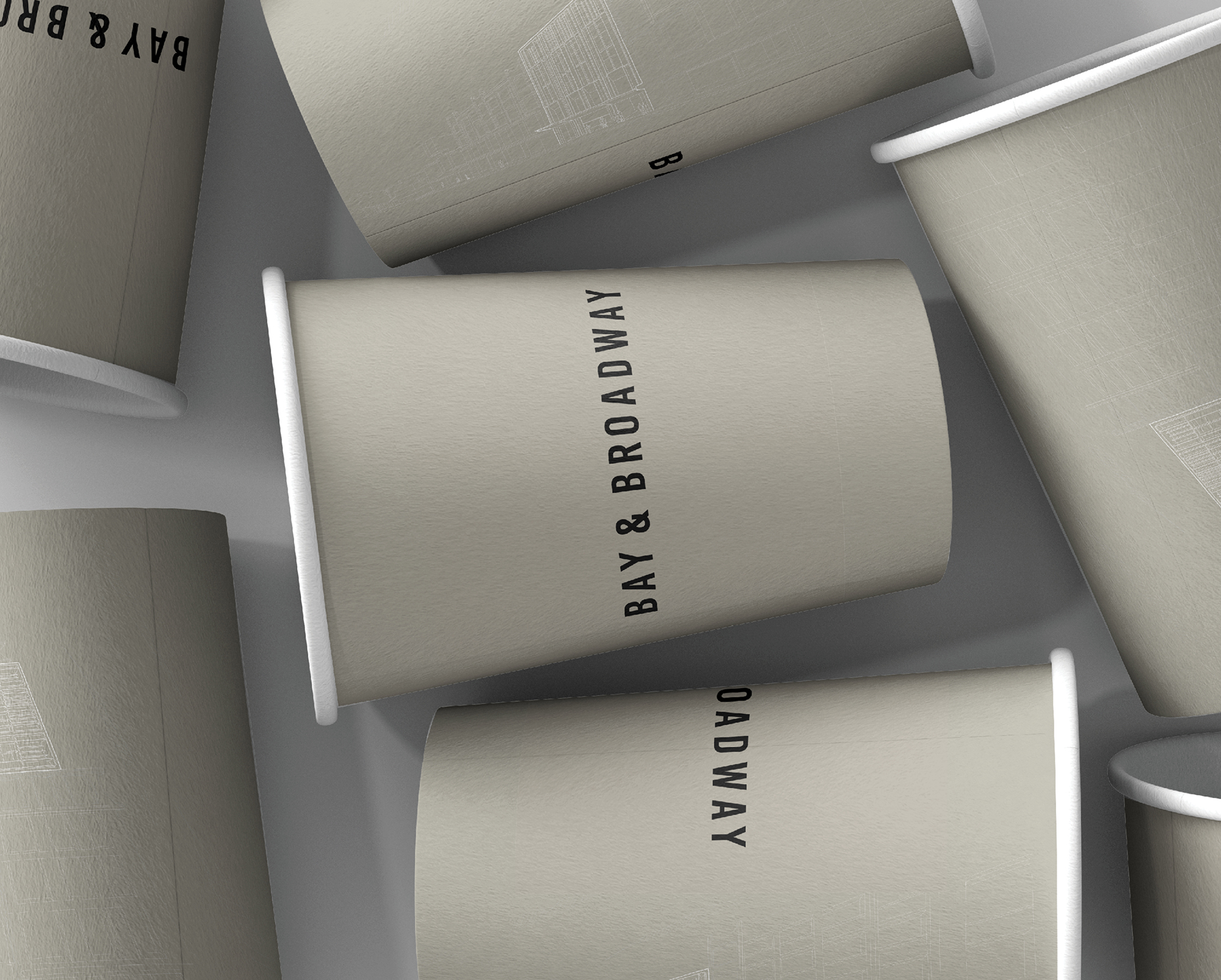 Branded coffee cups with Bay & Broadway logo, representing modern lifestyle and café culture at 86 Bay Street Ultimo Sydney.