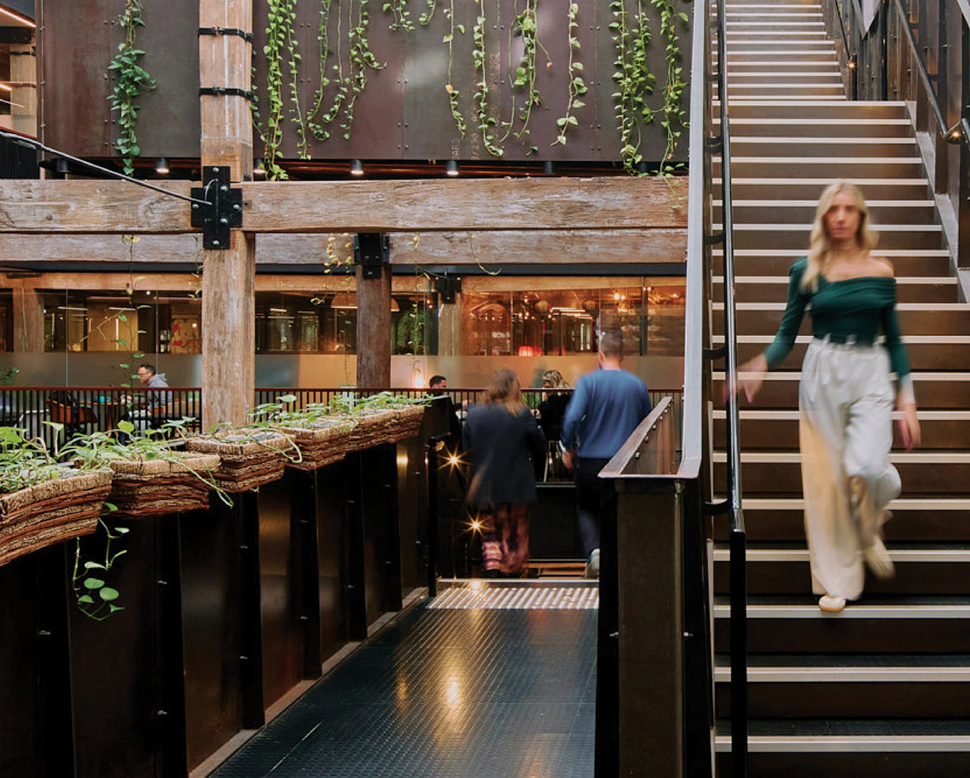 The Woolstore Pyrmont interior with exposed timber beams, industrial stairwell, and modern workspace design at 100 Harris Street Sydney.