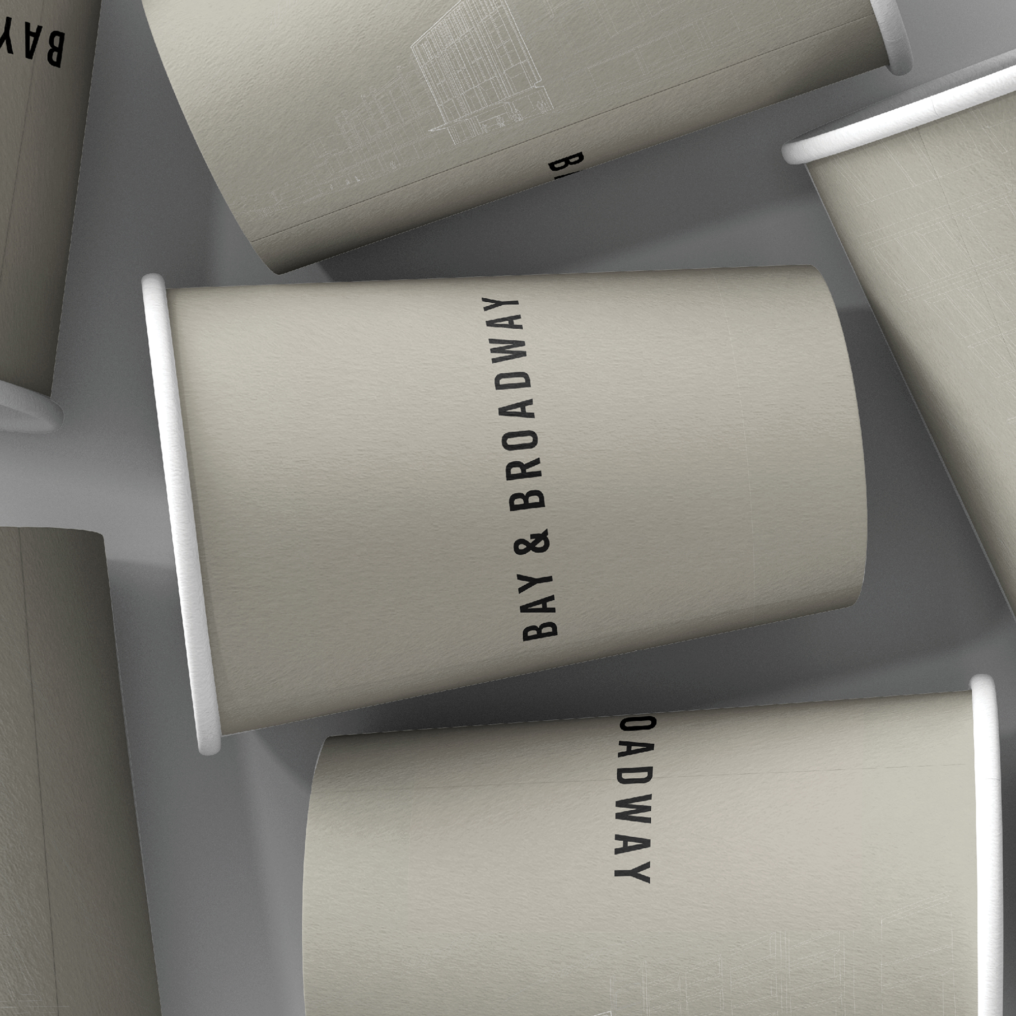 Branded coffee cups with Bay & Broadway logo, representing modern lifestyle and café culture at 86 Bay Street Ultimo Sydney