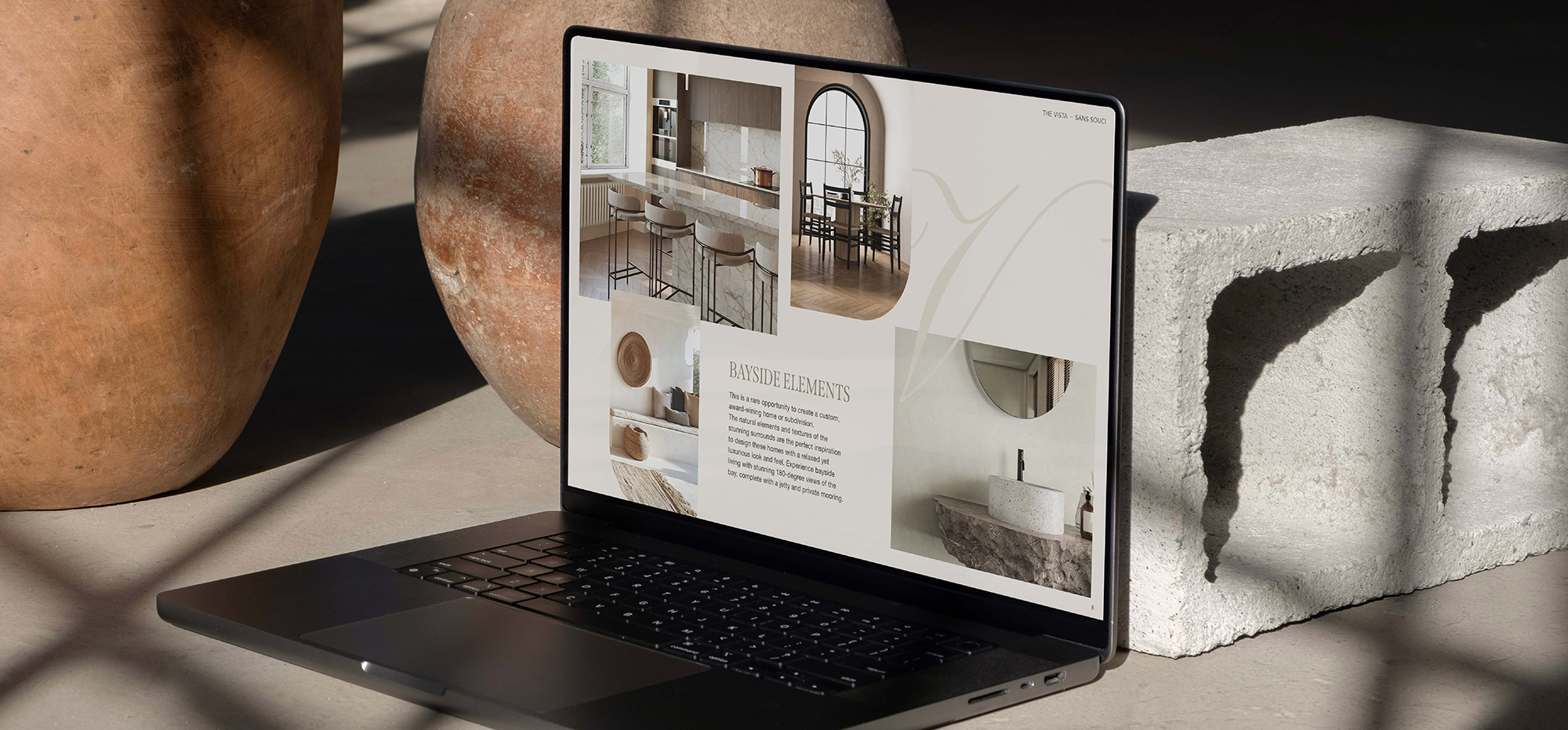 The Vista Sans Souci marketing presentation on laptop highlighting bayside design elements, premium finishes, and luxury lifestyle.
