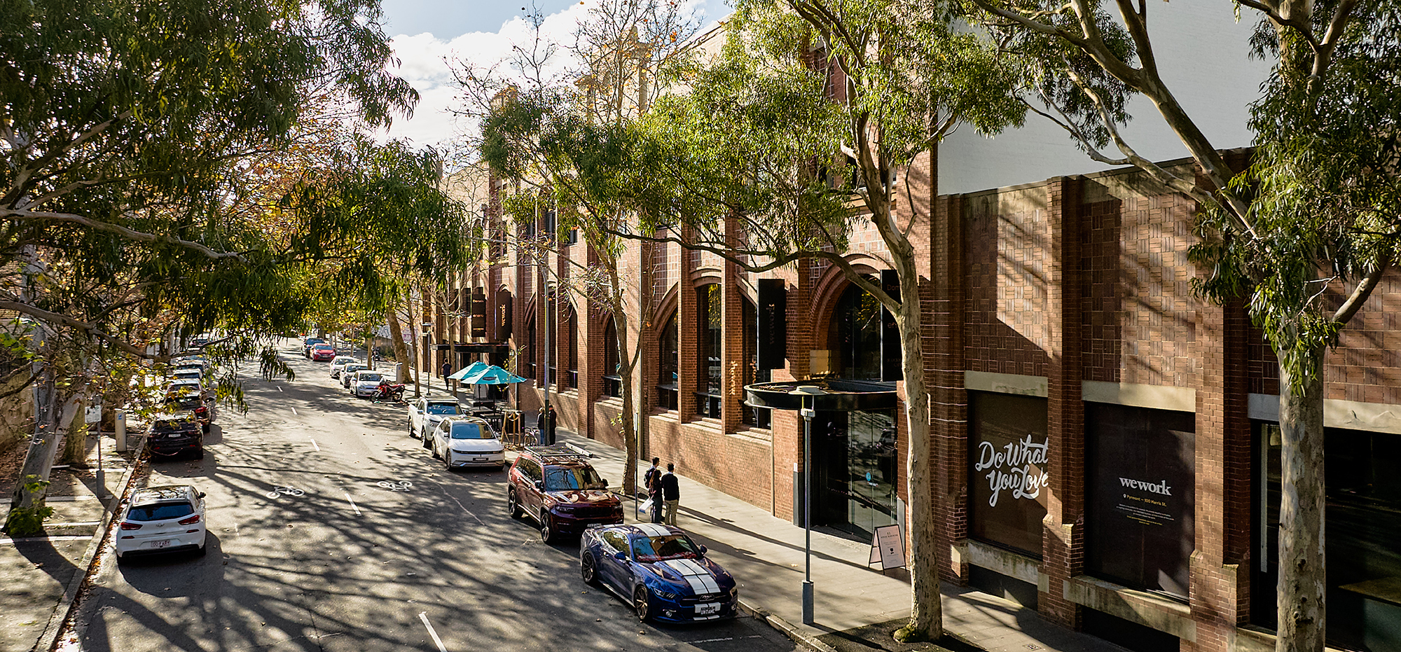 Street view of The Woolstore Pyrmont at 100–130 Harris Street, heritage warehouse offices with retail frontage in Sydney.