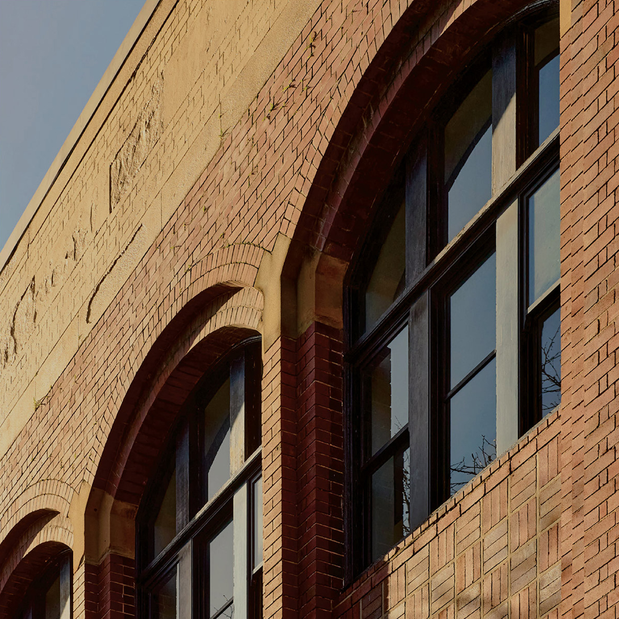 Detail of heritage brick façade at The Woolstore Pyrmont, showcasing arched windows and historic architecture at 100 Harris Street Sydney.