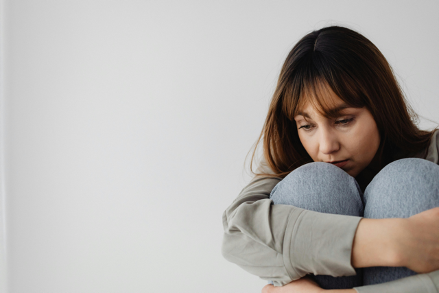 Woman experiencing anxiety and emotional distress after discovering infidelity in her relationship.