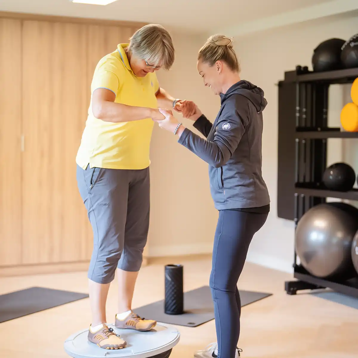 Eine Therapeutin bei der Sporttherapie mit einer Patientin