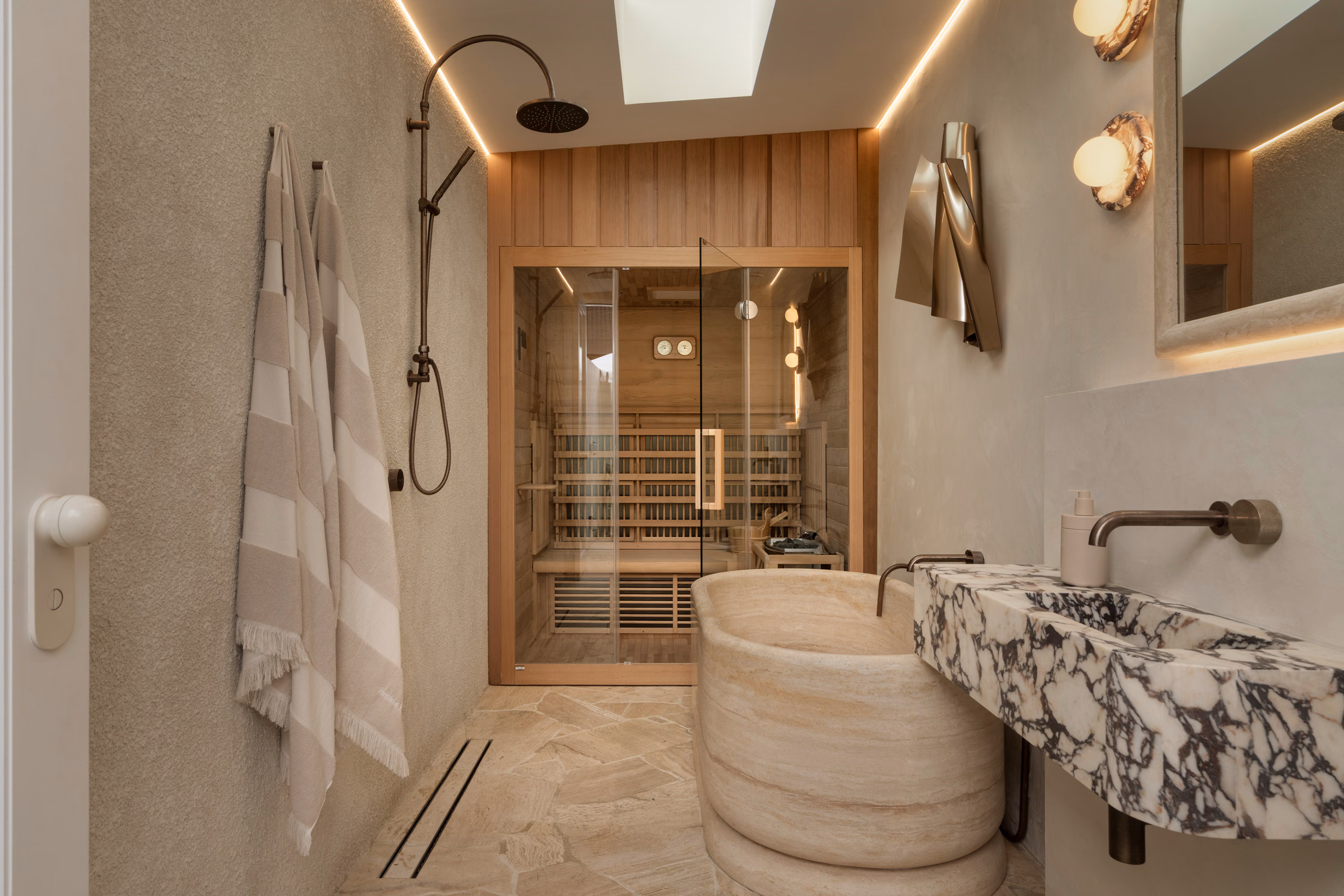 Modern ensuite bathroom with pink marble vanity and gold fixtures in a Brisbane architectural home.