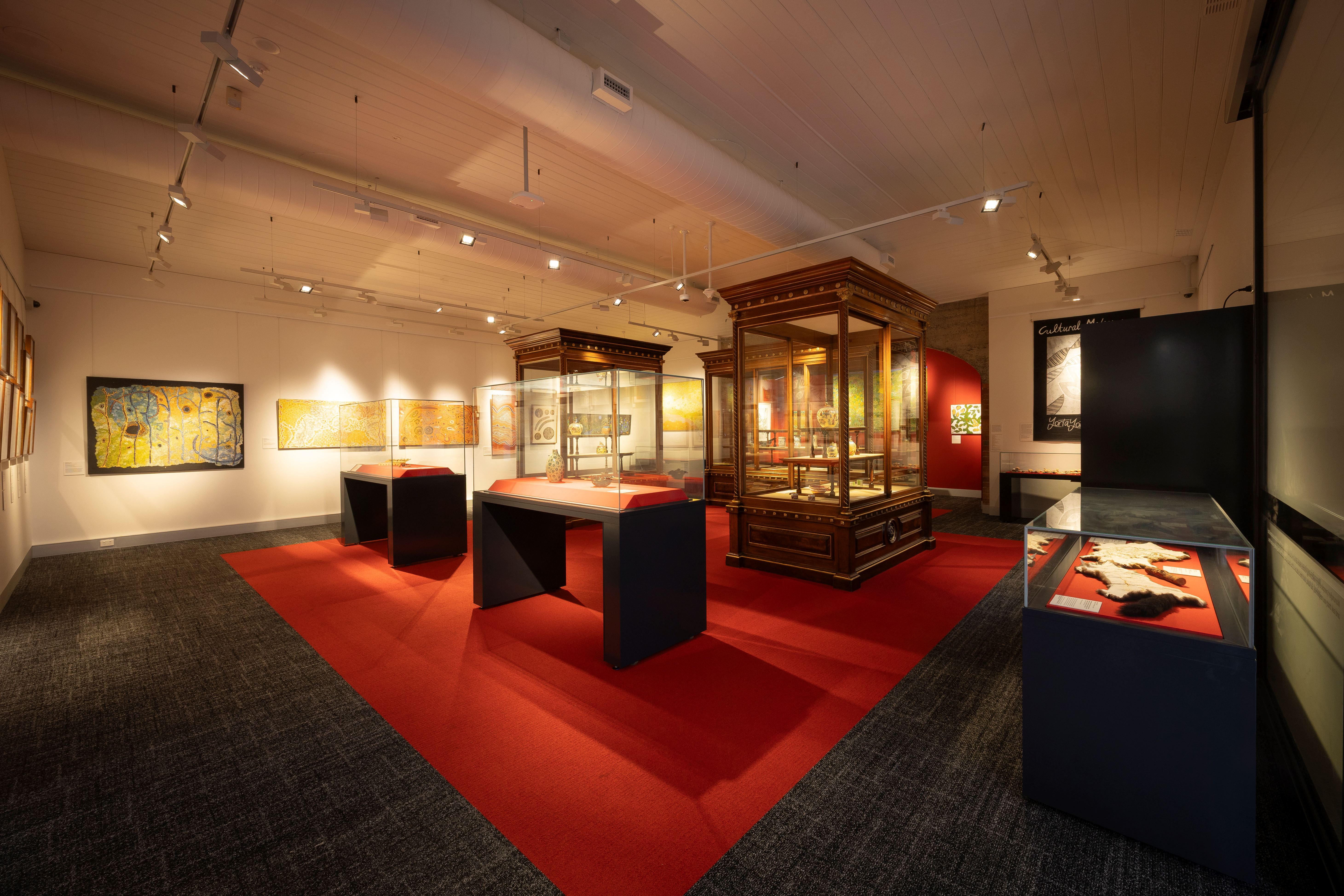 Medical History Museum with glass display cases, artwork and a vibrant red carpet.