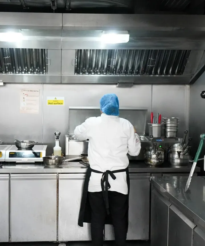 A chef at the pass in Encore's kitchen