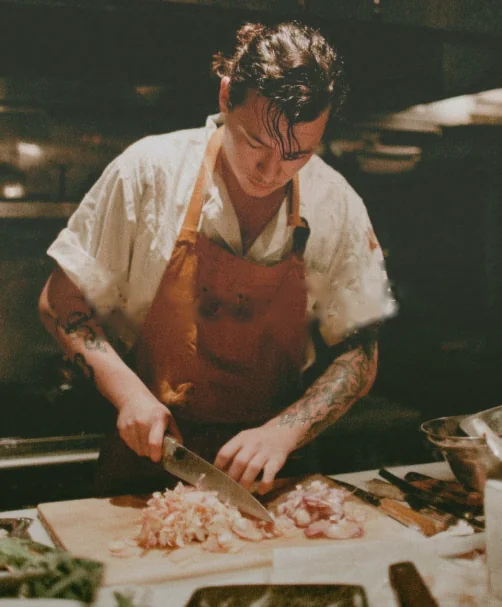 A chef preparing food in a restaurant kitchen