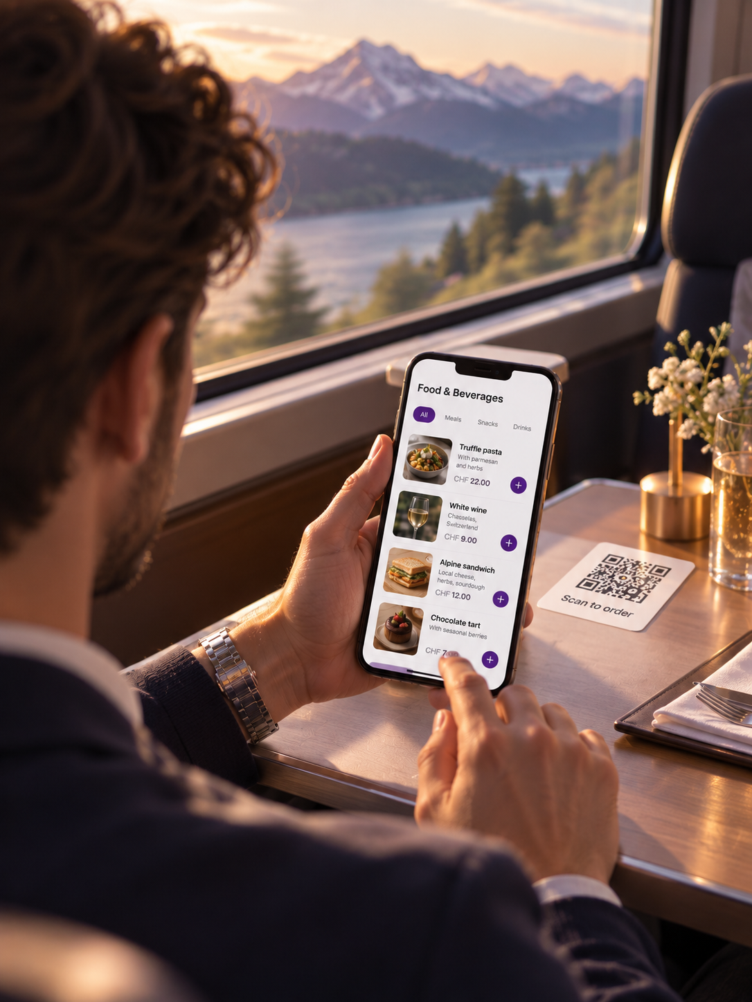 Rail passenger ordering food and drink from a phone at a table seat