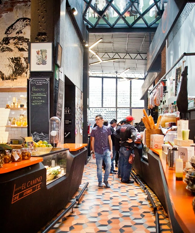 Urban market with vibrant corridor, food counters, and glass ceiling.