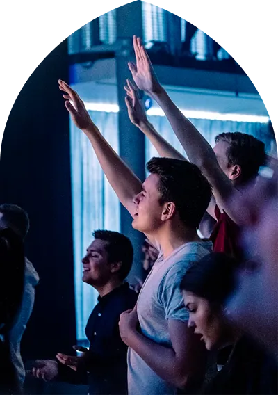 Group of people worshipping at an event