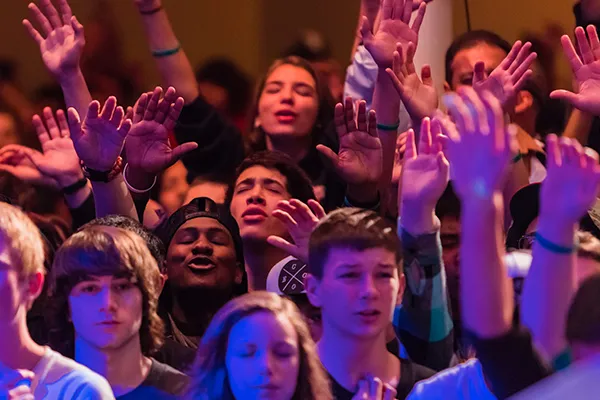Teenagers worshipping together.