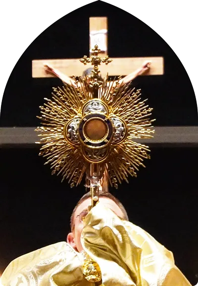 A priest holding up a monstrance.