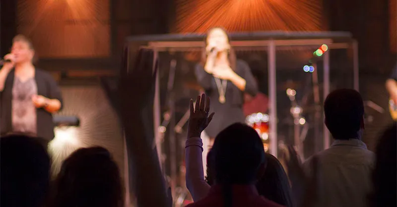 People worshipping in song